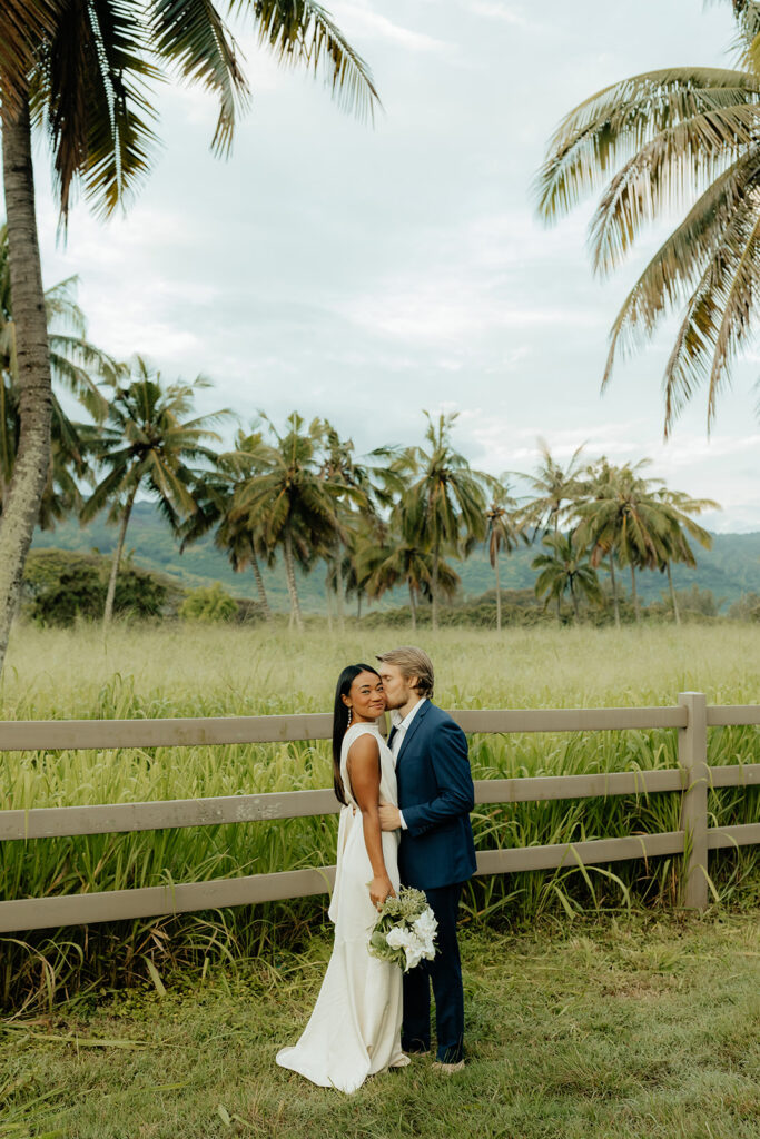 groom kissing the bride on the cheek