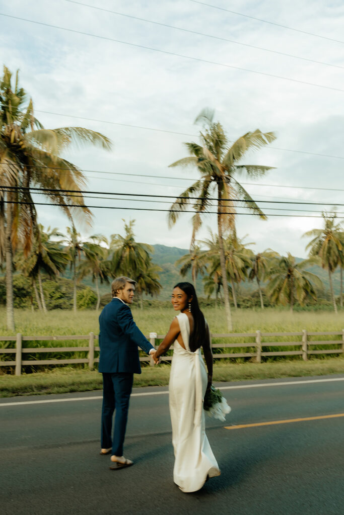 bride and groom walking around holding hands