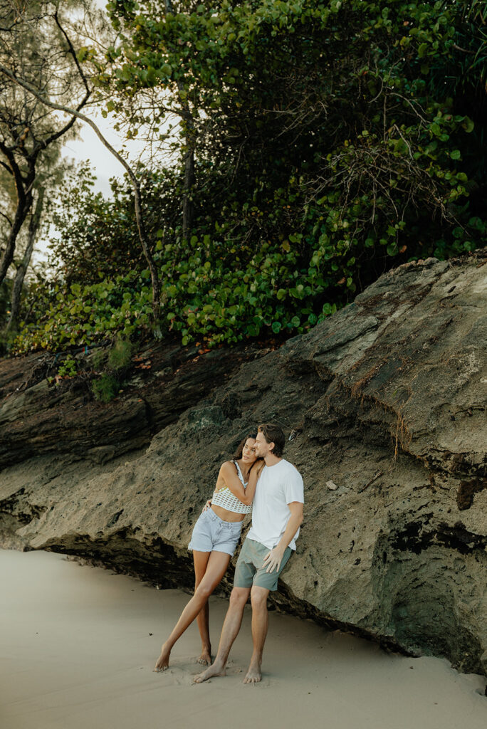 happy couple kissing during their session in oahu, HI