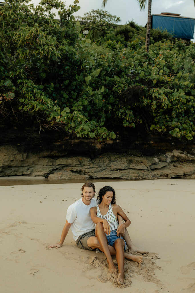 couple sitting looking at the beach 