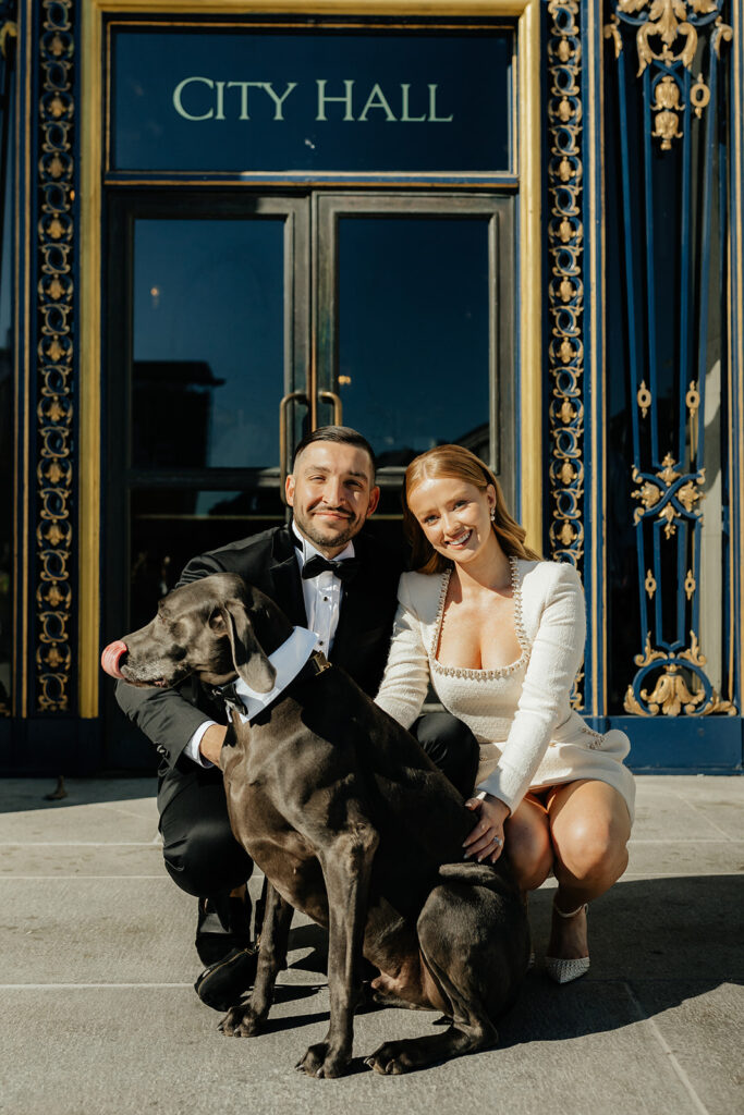 San Francisco City Hall Elopement outside front doors couple with dog in tuxedo