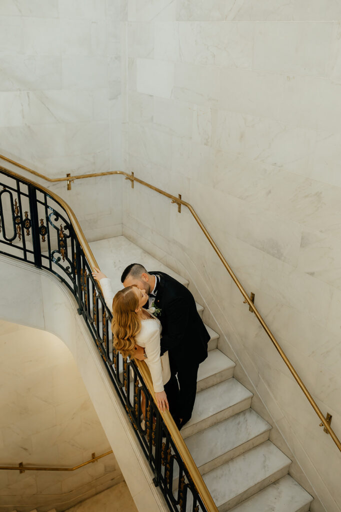 San Francisco City Hall Elopement couple arching over staircase