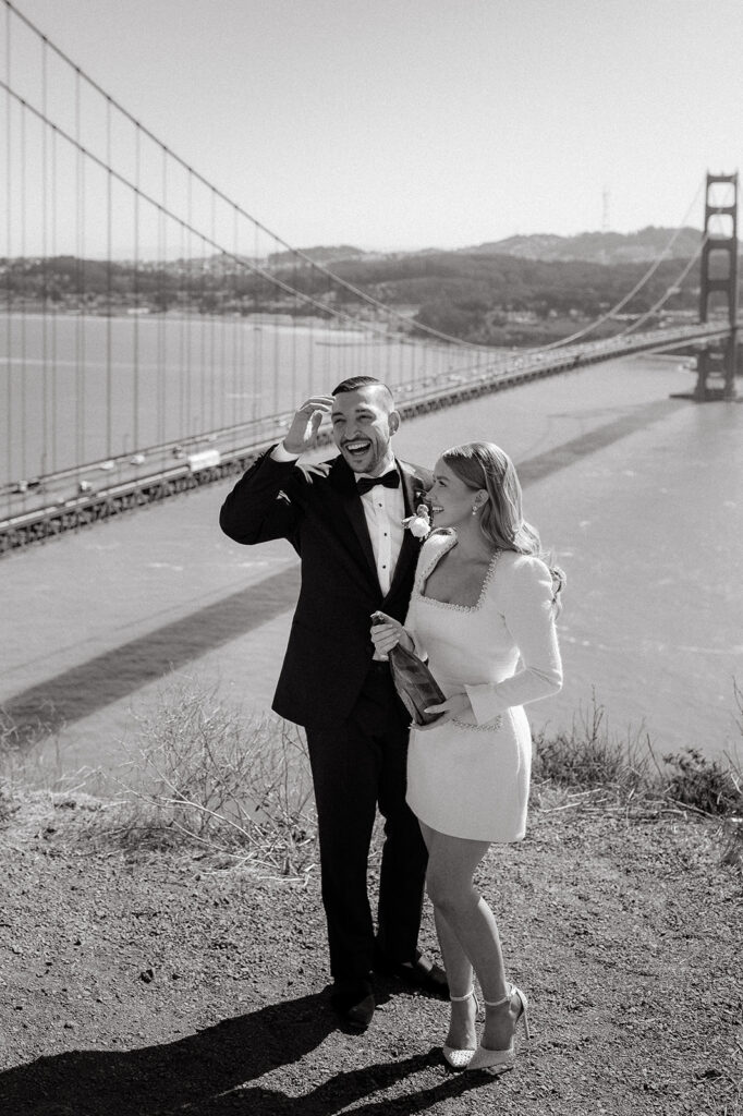 Elopement Couple at San Francisco Golden Gate bridge popping champagne