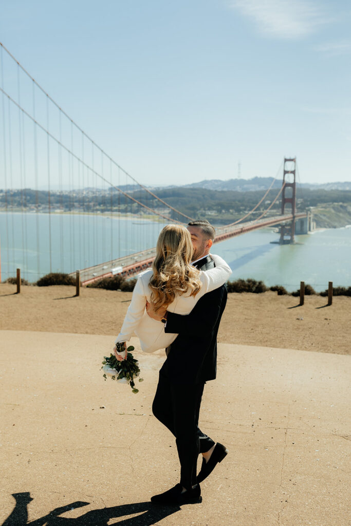 Elopement Couple at San Francisco Golden Gate bridge groom carrying bride away