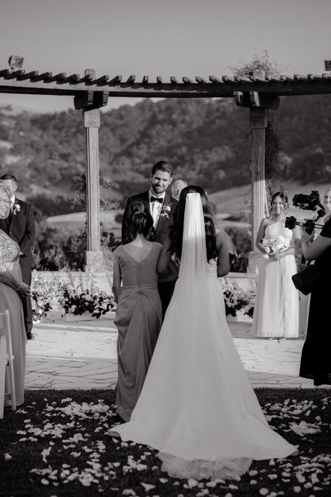 Clos LaChance Wedding ceremony bride walking down aisle with mom