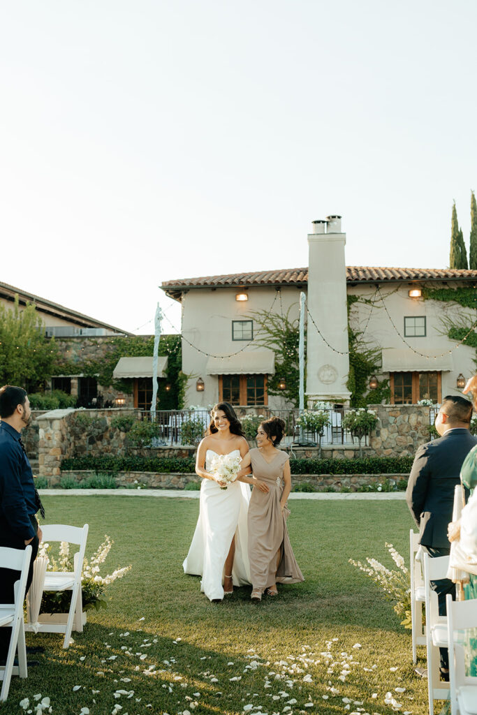 Clos LaChance Wedding ceremony bride walking down aisle with mom