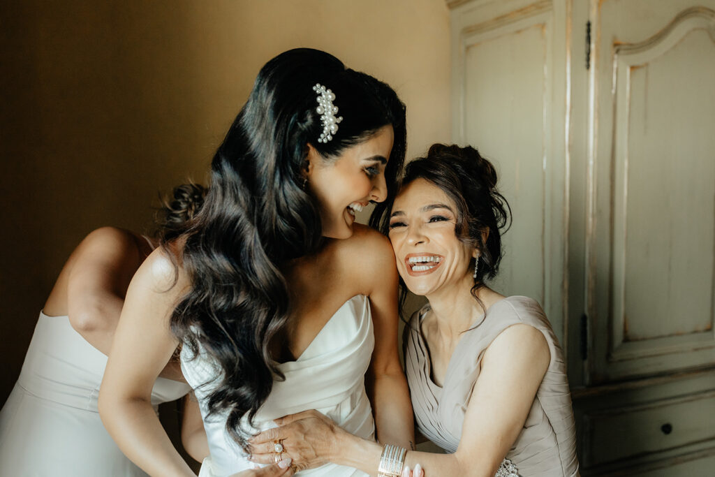 Clos LaChance Wedding - Bride laughing with mom indoors