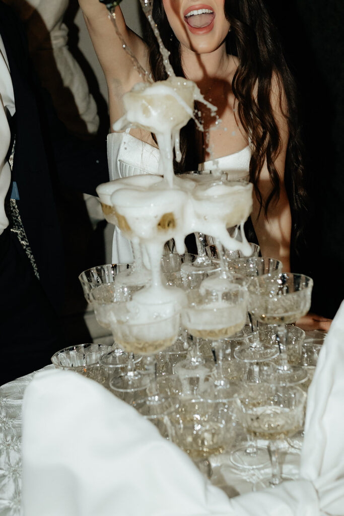 wedding chic couple at cocktail hour holding drinks