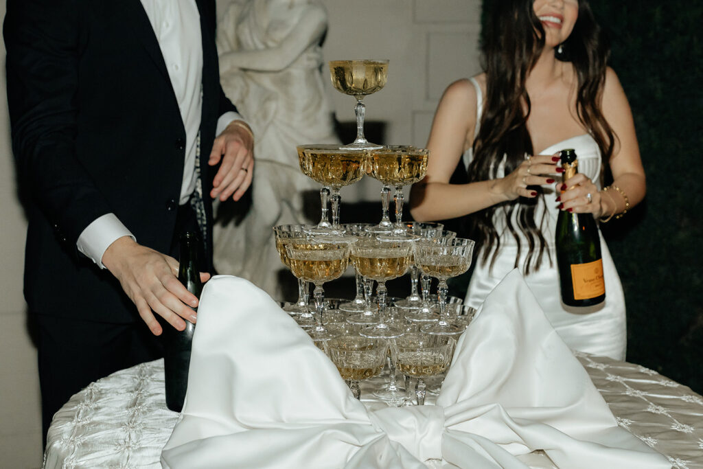 wedding chic couple in front of champagne tower