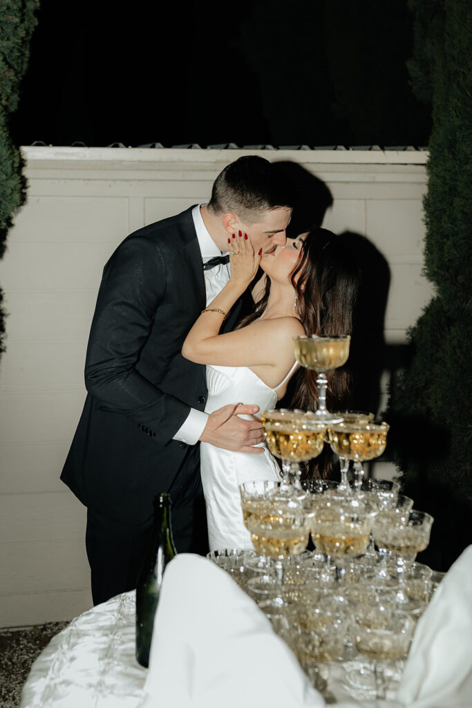 Grand island mansion wedding chic couple in front of champagne tower